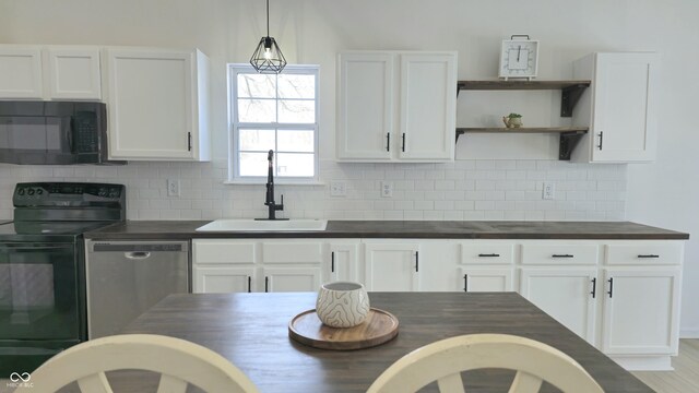 kitchen featuring black appliances, backsplash, white cabinetry, and sink