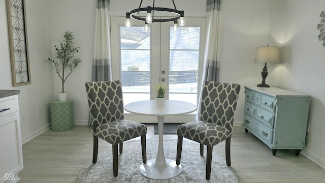 dining space featuring french doors and light hardwood / wood-style flooring