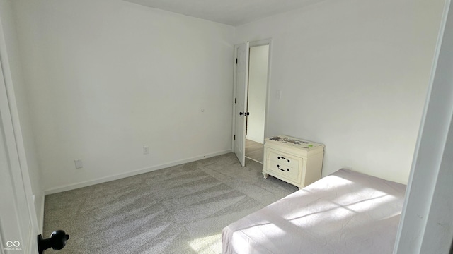 unfurnished bedroom featuring light colored carpet