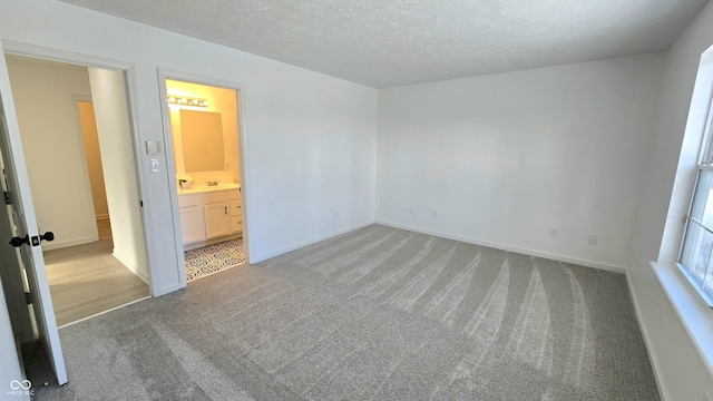 carpeted spare room with a textured ceiling