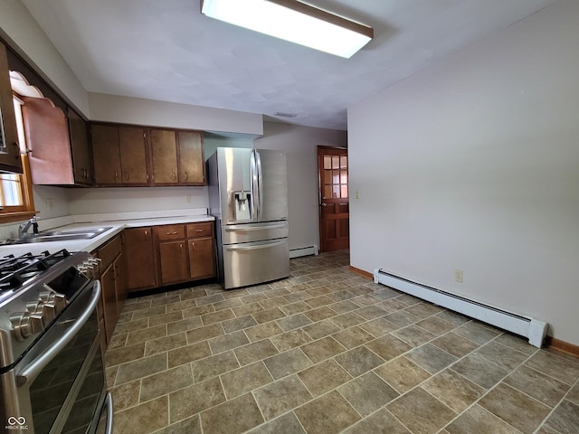 kitchen featuring baseboard heating, stainless steel appliances, dark brown cabinetry, and sink