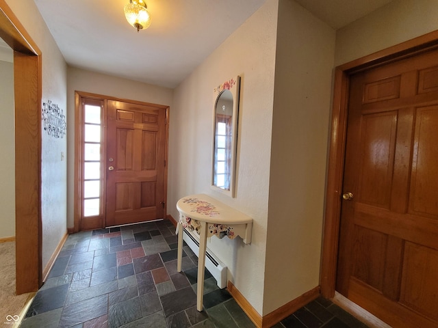 foyer featuring plenty of natural light and baseboard heating