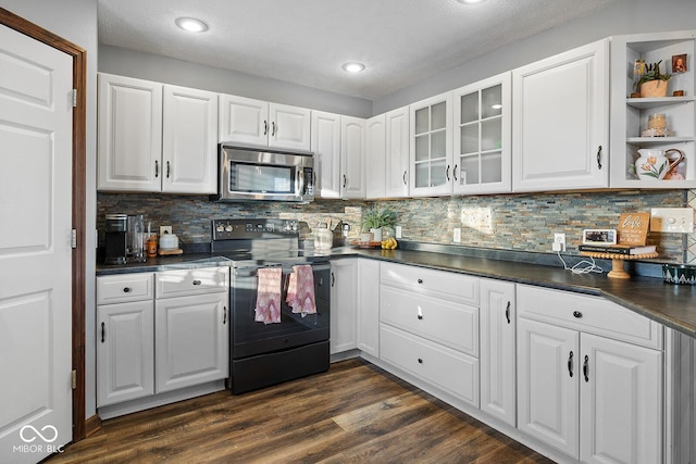 kitchen featuring a textured ceiling, white cabinetry, dark hardwood / wood-style flooring, tasteful backsplash, and electric range