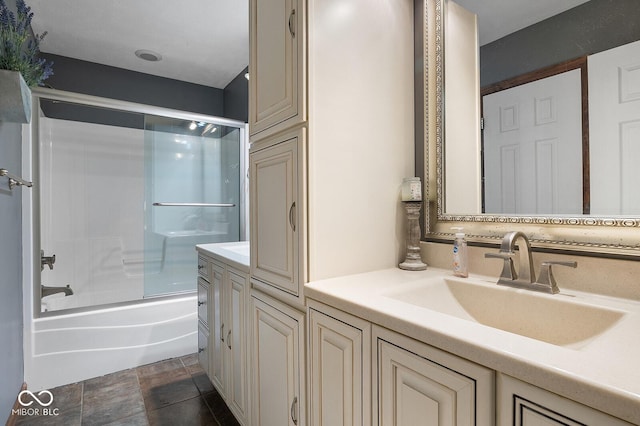 bathroom with vanity and combined bath / shower with glass door