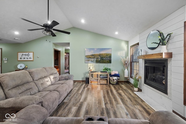 living room with ceiling fan, hardwood / wood-style floors, and lofted ceiling