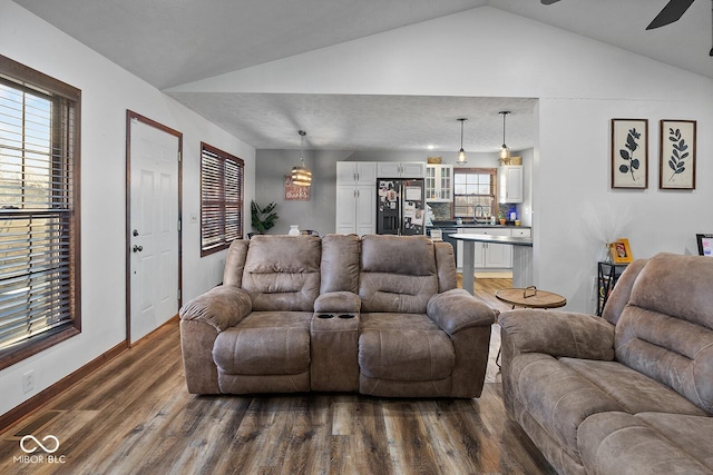 living room featuring sink, ceiling fan, dark hardwood / wood-style floors, and lofted ceiling