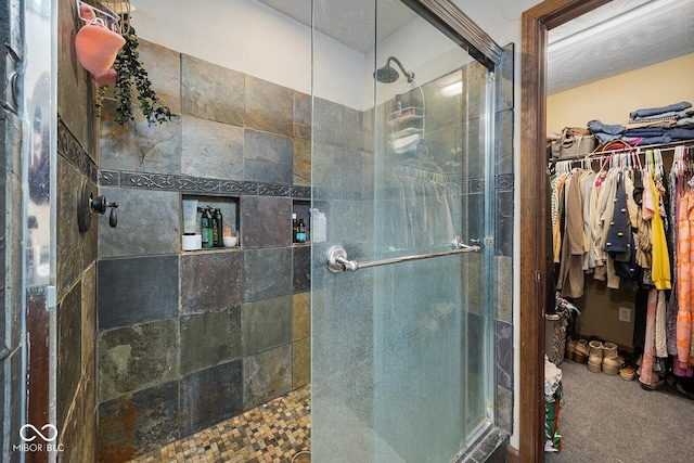 bathroom featuring a textured ceiling and an enclosed shower