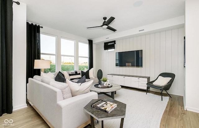 living room featuring ceiling fan and light hardwood / wood-style flooring