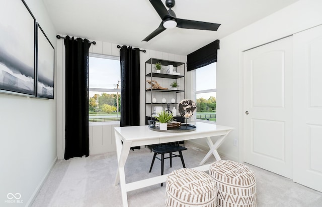 carpeted office space with ceiling fan