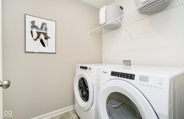 clothes washing area with light tile patterned floors and washer and clothes dryer