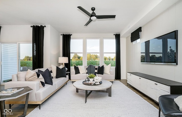 living room with hardwood / wood-style flooring and ceiling fan