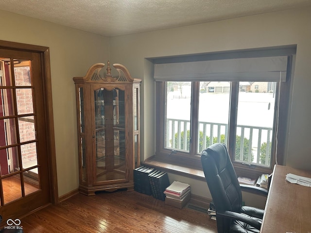 office area with hardwood / wood-style flooring and a textured ceiling