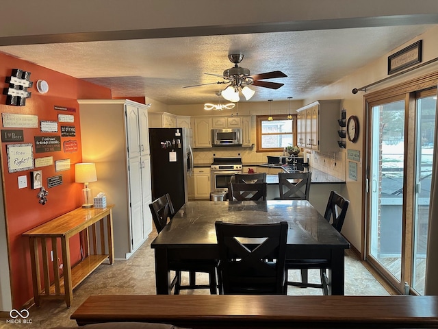 dining space featuring a textured ceiling and ceiling fan