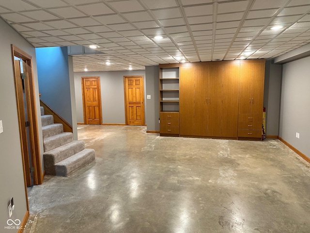 basement featuring wooden walls