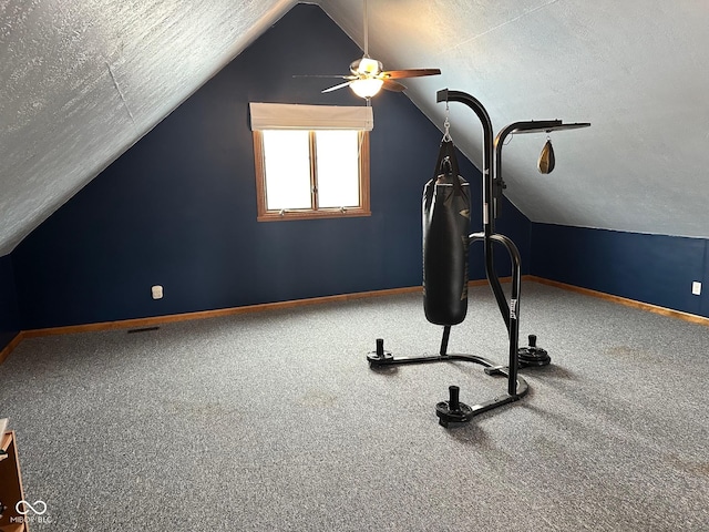 workout room featuring carpet floors, a textured ceiling, and vaulted ceiling