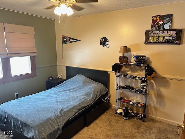 bedroom with a textured ceiling, ceiling fan, and carpet