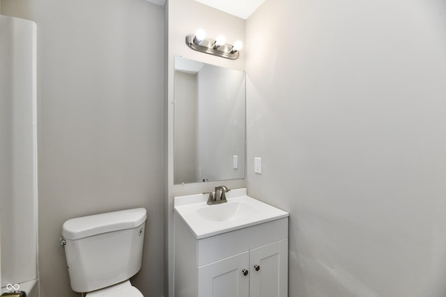 bathroom with toilet and vanity