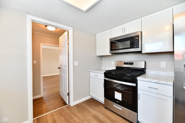 kitchen featuring white cabinetry, light hardwood / wood-style flooring, and stainless steel appliances