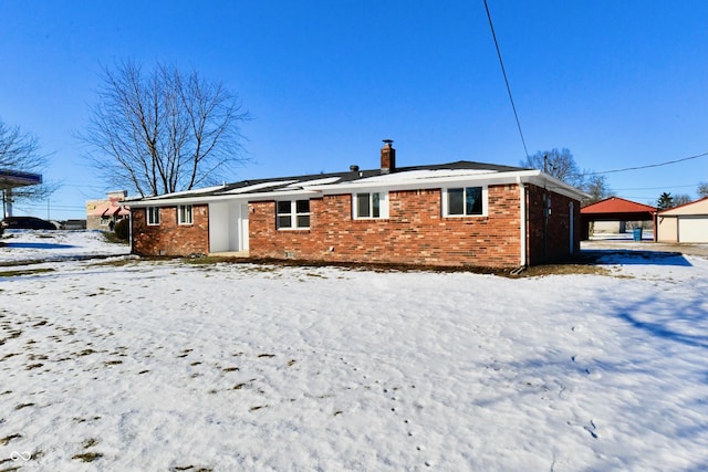 snow covered property with a garage