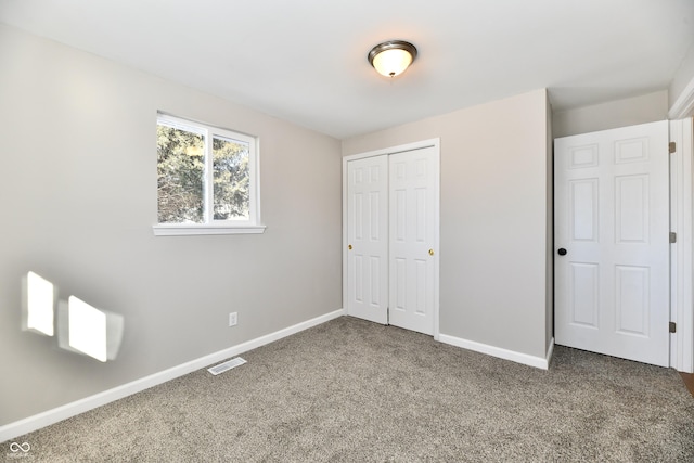 unfurnished bedroom featuring carpet floors and a closet