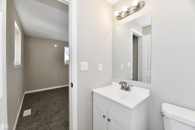 bathroom featuring toilet and vanity