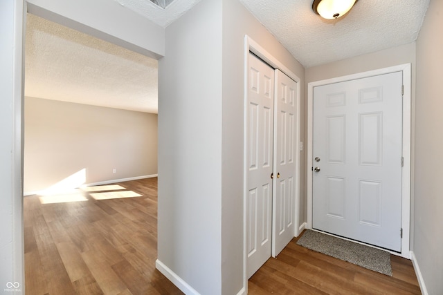 entrance foyer featuring a textured ceiling and hardwood / wood-style floors