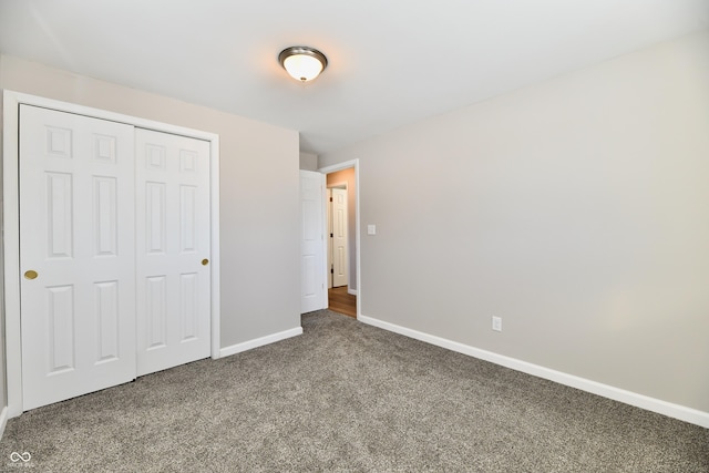 unfurnished bedroom featuring a closet and carpet flooring