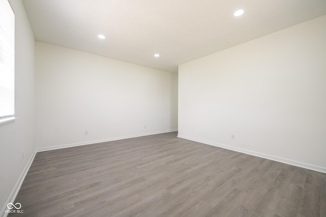 303 Doe Creek Dr, Cloverdale, IN 46120 - empty room featuring wood finished floors, recessed lighting, and baseboards