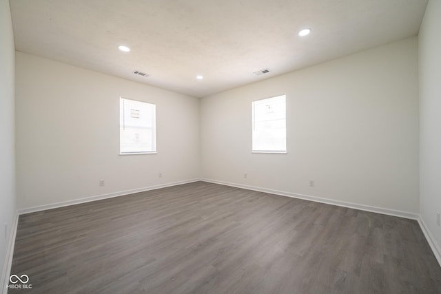 303 Doe Creek Dr, Cloverdale, IN 46120 - empty room featuring plenty of natural light, dark wood-style floors, recessed lighting, and baseboards