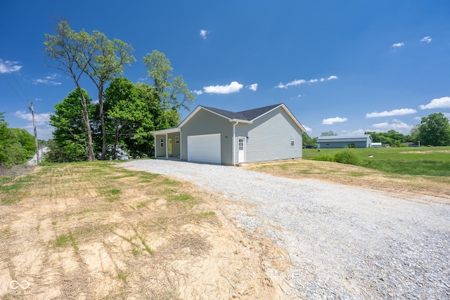 303 Doe Creek Dr, Cloverdale, IN 46120 - view of side of home featuring a garage and gravel driveway