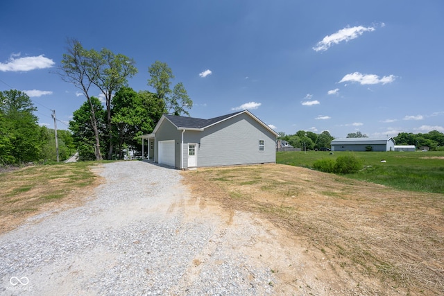 303 Doe Creek Dr, Cloverdale, IN 46120 - view of side of home featuring an attached garage and driveway