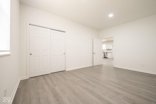 303 Doe Creek Dr, Cloverdale, IN 46120 - unfurnished bedroom with wood finished floors, baseboards, recessed lighting, and a closet