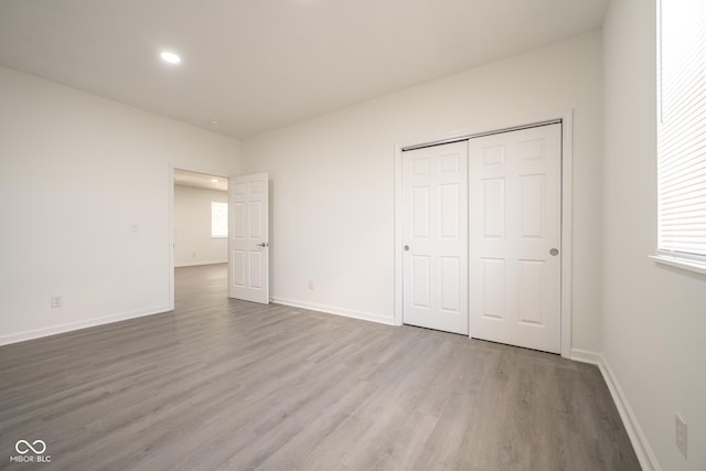 303 Doe Creek Dr, Cloverdale, IN 46120 - unfurnished bedroom featuring wood finished floors, baseboards, recessed lighting, and a closet