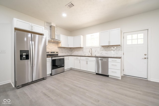 303 Doe Creek Dr, Cloverdale, IN 46120 - kitchen featuring stainless steel appliances, wall chimney range hood, a sink, light wood-style flooring, and recessed lighting
