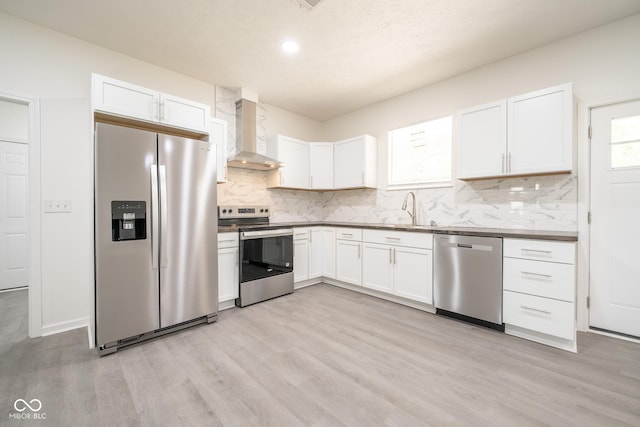 303 Doe Creek Dr, Cloverdale, IN 46120 - kitchen featuring appliances with stainless steel finishes, wall chimney exhaust hood, a sink, light wood-style floors, and recessed lighting