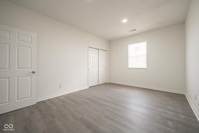 303 Doe Creek Dr, Cloverdale, IN 46120 - unfurnished bedroom featuring dark wood-type flooring, baseboards, recessed lighting, and a closet