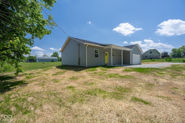 303 Doe Creek Dr, Cloverdale, IN 46120 - rear view of house featuring driveway, a lawn, and a garage