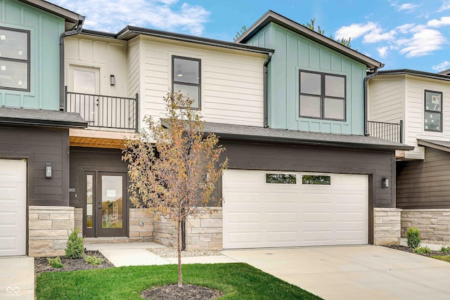 view of property with a garage and a balcony