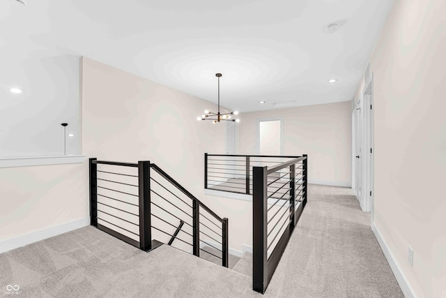 staircase featuring an inviting chandelier and carpet flooring