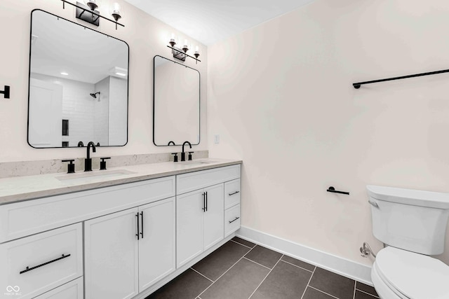 bathroom featuring toilet, a shower, tile patterned floors, and vanity