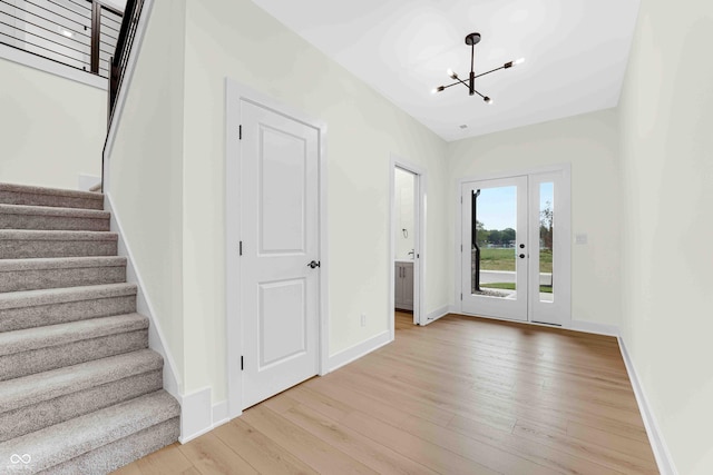 entryway featuring light hardwood / wood-style floors and a notable chandelier