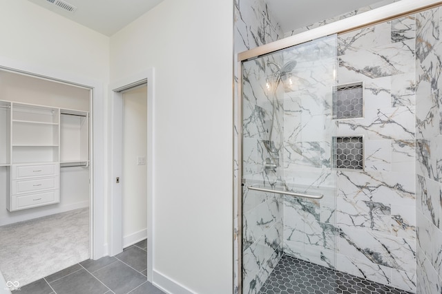 bathroom featuring an enclosed shower and tile patterned floors