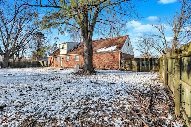 2934 S Irwin St, Indianapolis, IN 46203 - snow covered property featuring brick siding and a fenced backyard