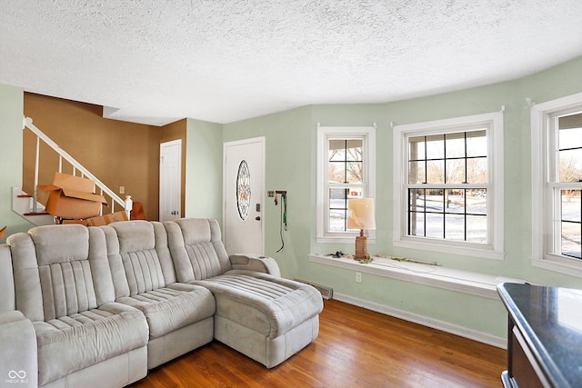 2934 S Irwin St, Indianapolis, IN 46203 - living area with wood finished floors, stairway, a textured ceiling, and baseboards