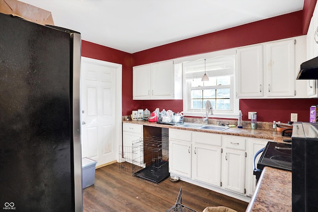 2934 S Irwin St, Indianapolis, IN 46203 - kitchen with freestanding refrigerator, a sink, dark wood-style flooring, white cabinetry, and black range with electric cooktop