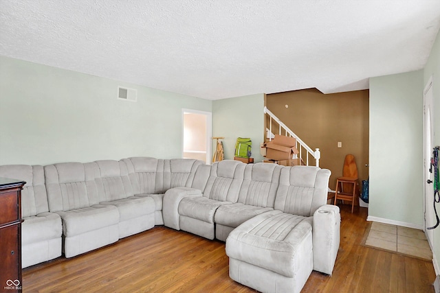2934 S Irwin St, Indianapolis, IN 46203 - living area featuring wood finished floors, stairway, baseboards, and a textured ceiling