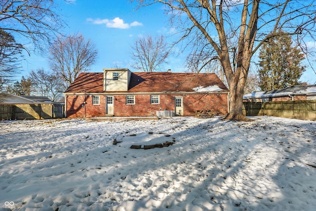 2934 S Irwin St, Indianapolis, IN 46203 - snow covered house with brick siding, a fenced backyard, and cooling unit