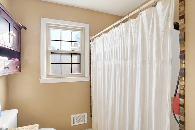 2934 S Irwin St, Indianapolis, IN 46203 - bathroom with toilet and a shower with shower curtain