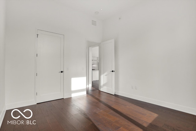 unfurnished bedroom featuring dark hardwood / wood-style floors