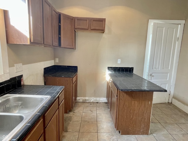 kitchen with sink and light tile patterned flooring